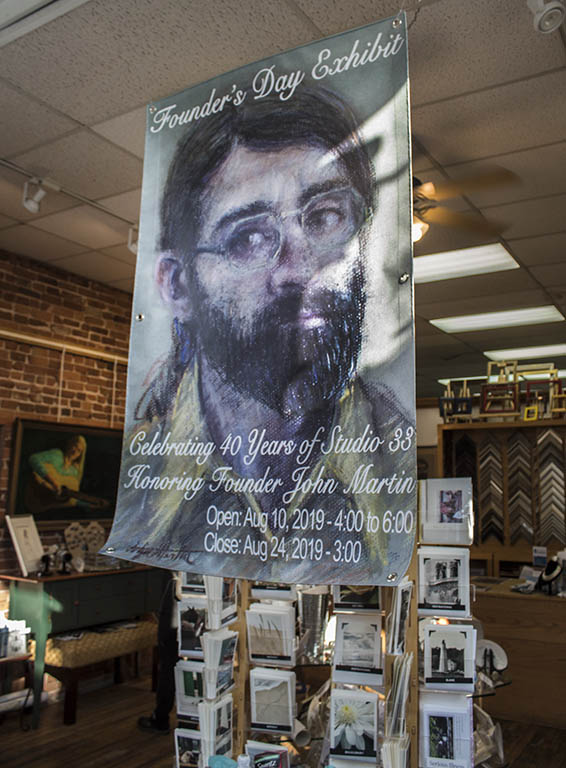 Poster of Exhibit Announcement featuring a pastel self portrait of John Martin